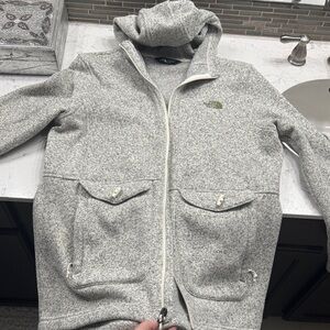 The North Face women’s Light Gray Jacket with olive green back tones